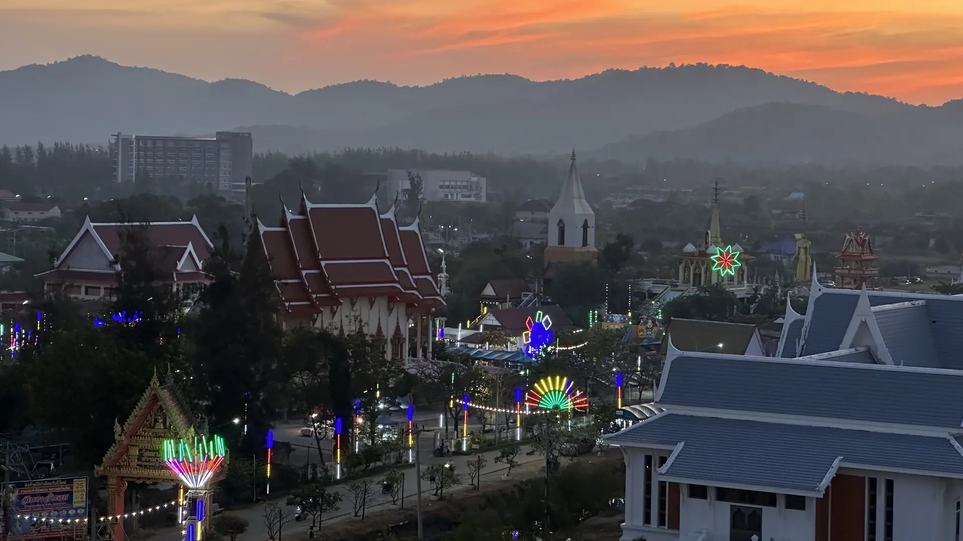 Temple fair lights in Hua Hin with the hills behind