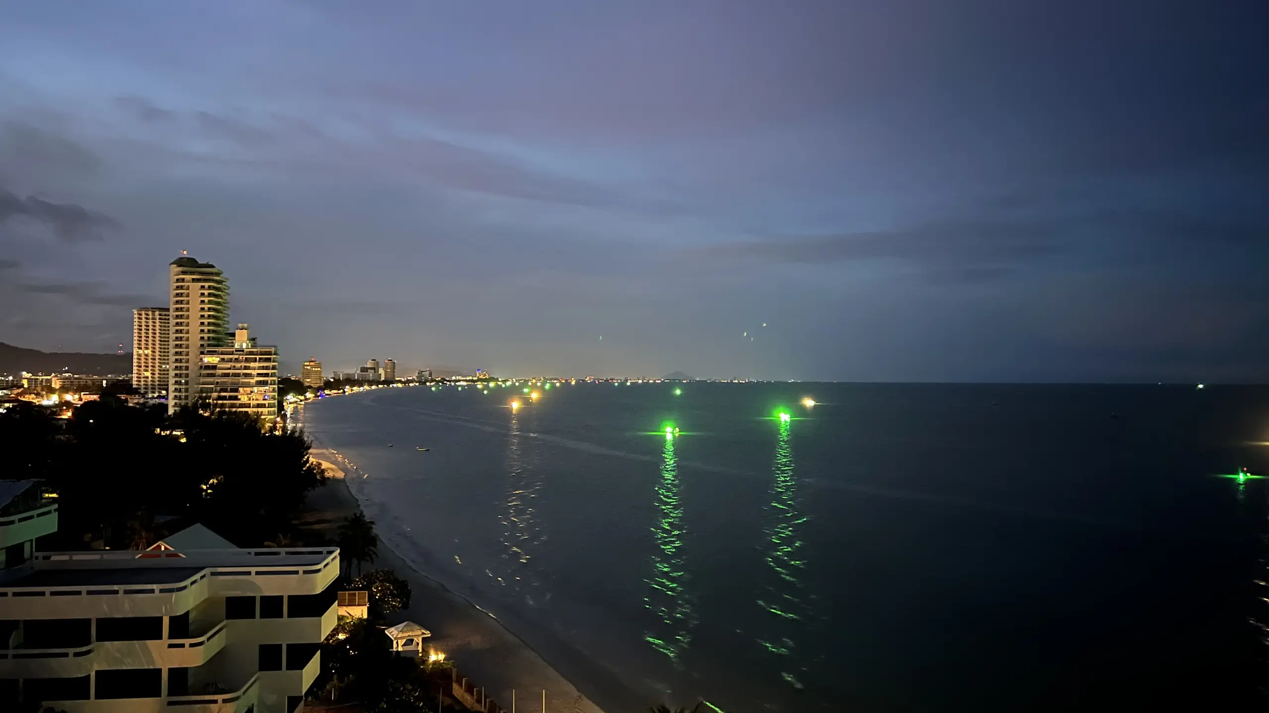 Hua Hin city lights and fishing boats on the water at night